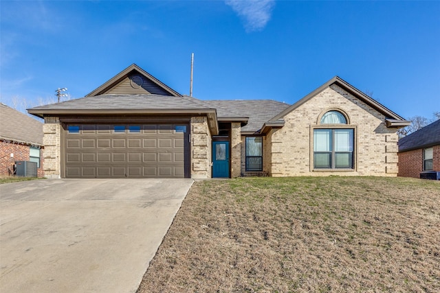 view of front facade featuring a front lawn, a garage, and central AC