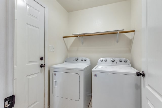 clothes washing area with washing machine and clothes dryer