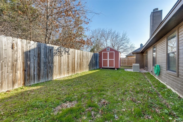 view of yard with central AC unit and a storage unit