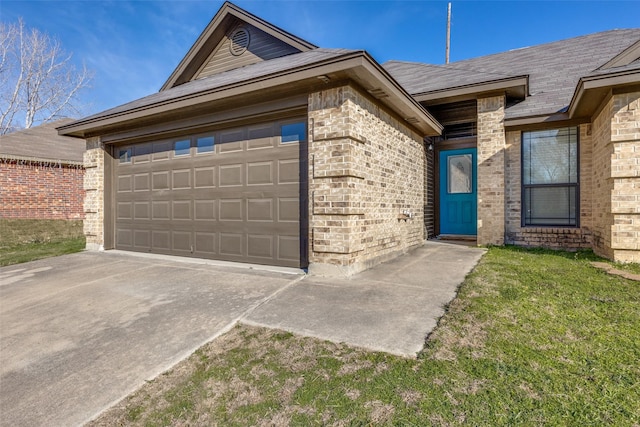 view of front of house with a front yard and a garage