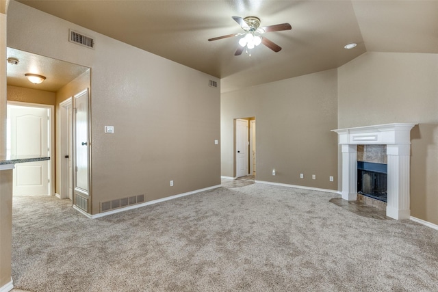 unfurnished living room with light carpet, ceiling fan, a tile fireplace, and lofted ceiling