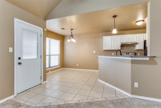 kitchen featuring white cabinetry, light tile patterned floors, and hanging light fixtures