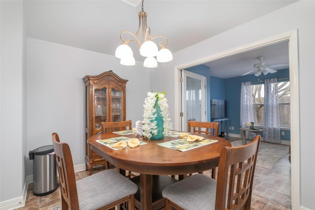 dining room with ceiling fan with notable chandelier