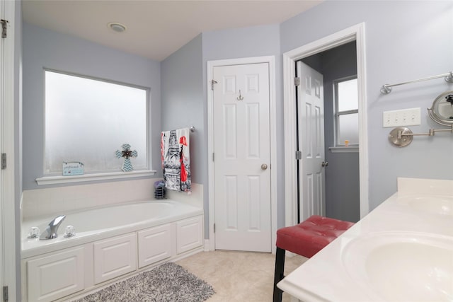 bathroom with a tub to relax in and vanity