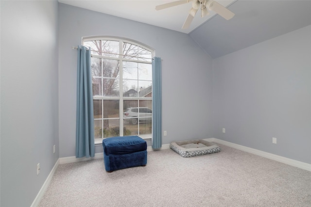 living area with ceiling fan, carpet floors, and lofted ceiling