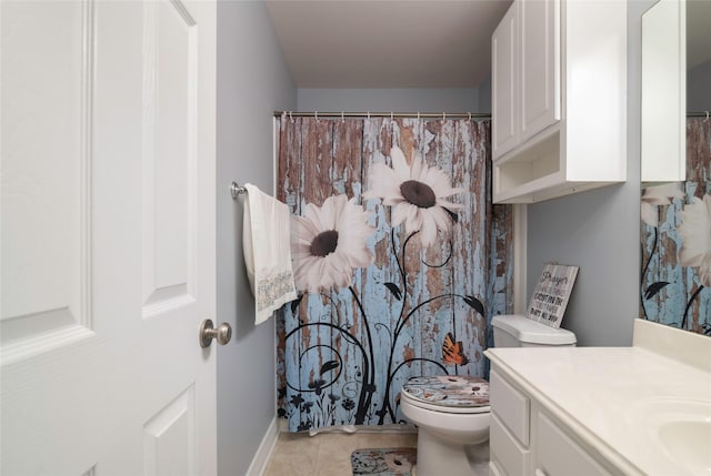 bathroom featuring toilet, tile patterned flooring, and vanity