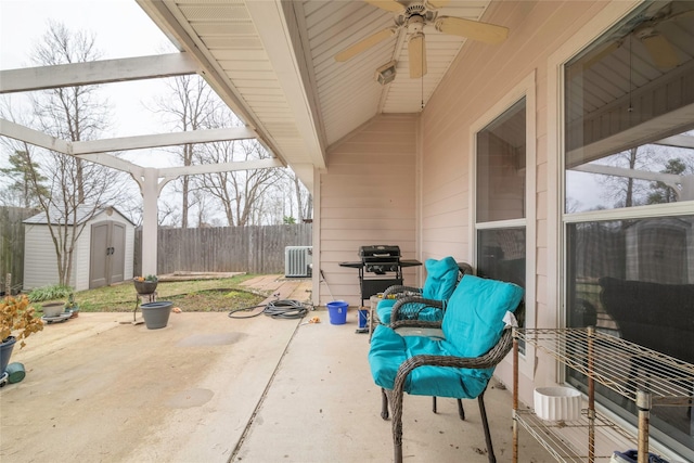 view of patio featuring central air condition unit, a shed, and grilling area