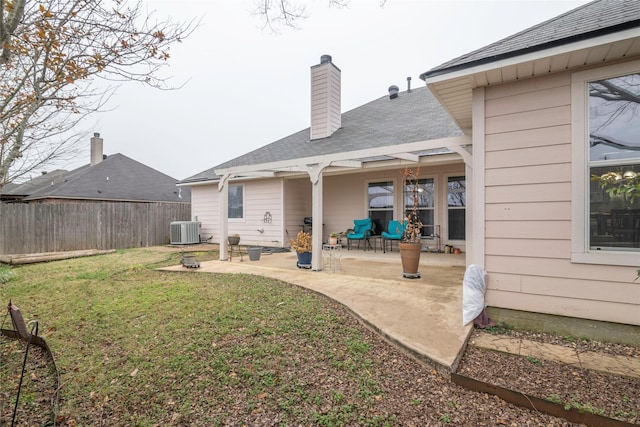 back of house featuring a patio, central AC unit, and a yard