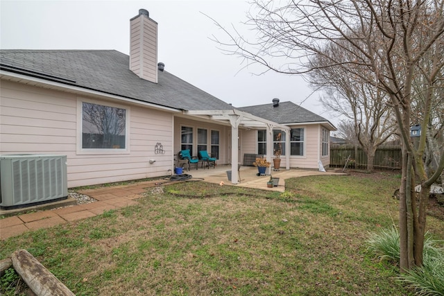 rear view of house featuring a patio, cooling unit, and a yard