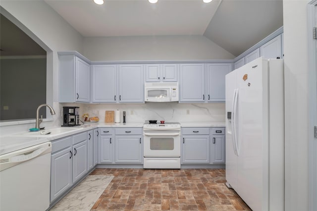 kitchen featuring sink, backsplash, white appliances, and lofted ceiling