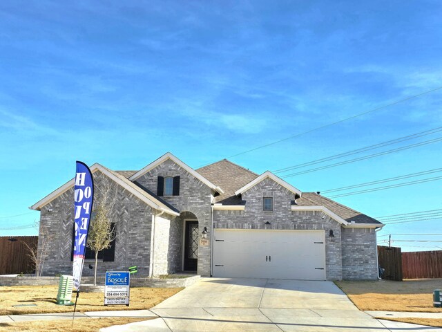 french country inspired facade with a garage