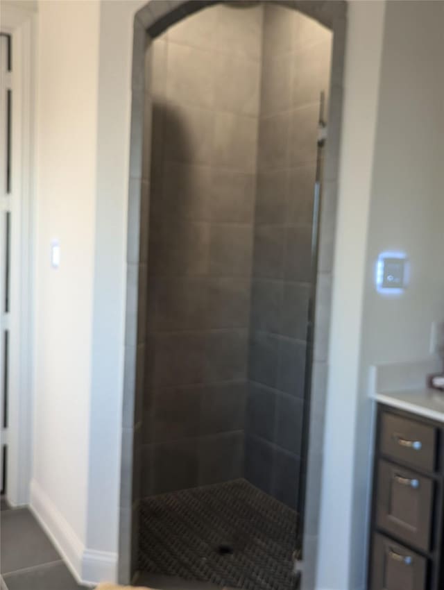 bathroom with vanity, tile patterned floors, and tiled shower