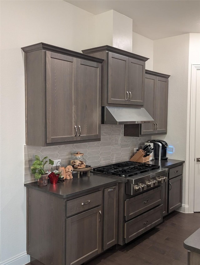 kitchen featuring decorative backsplash, dark brown cabinets, dark hardwood / wood-style flooring, and stainless steel gas cooktop