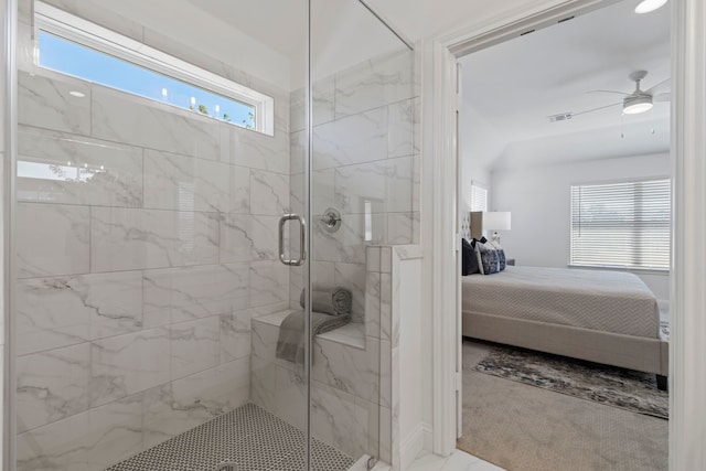 bathroom featuring a shower with shower door and ceiling fan