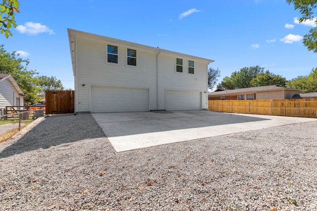 back of house featuring a garage