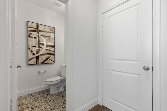 bathroom with toilet and tile patterned floors