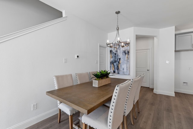 dining room featuring dark hardwood / wood-style flooring and an inviting chandelier