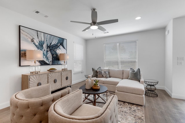 living room featuring ceiling fan and light hardwood / wood-style floors