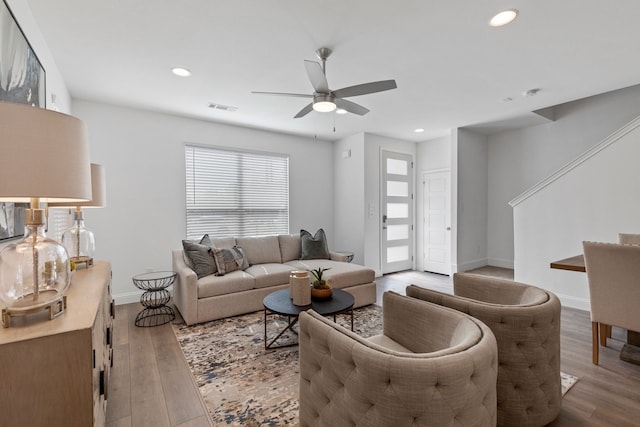 living room featuring ceiling fan and light hardwood / wood-style flooring