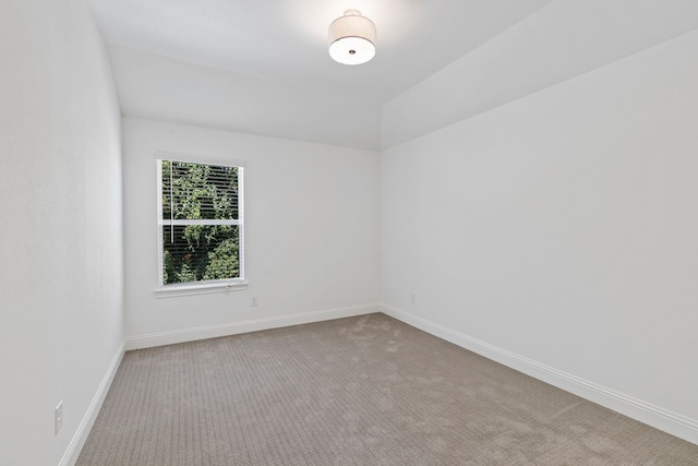 spare room featuring light colored carpet