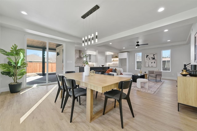 dining space with light hardwood / wood-style floors and ceiling fan