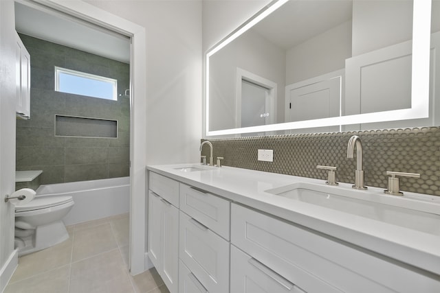 full bathroom with toilet, tiled shower / bath combo, backsplash, tile patterned flooring, and vanity