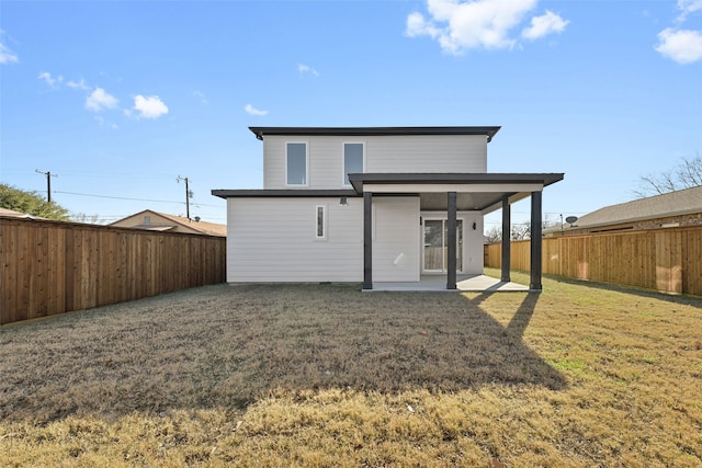 back of property featuring a lawn and a patio