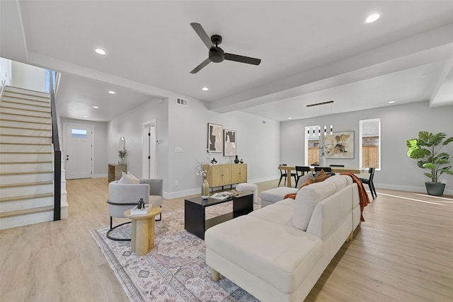 living room with light wood-type flooring and ceiling fan