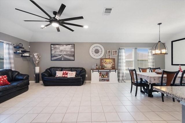 living room with ceiling fan, light tile patterned floors, and lofted ceiling