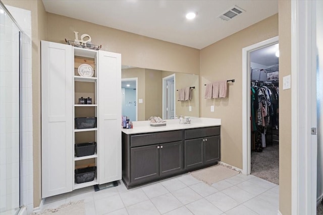 bathroom featuring an enclosed shower, vanity, and tile patterned floors