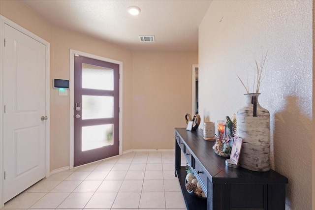 entryway with light tile patterned floors