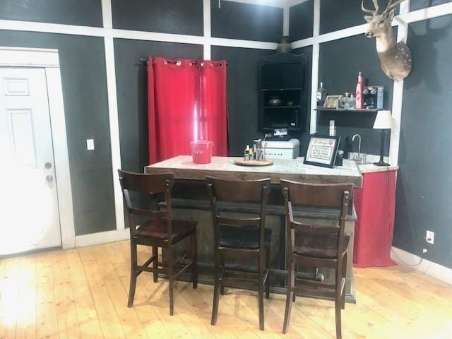 bar featuring light hardwood / wood-style floors