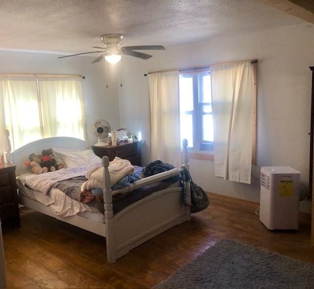 bedroom featuring ceiling fan and dark hardwood / wood-style flooring