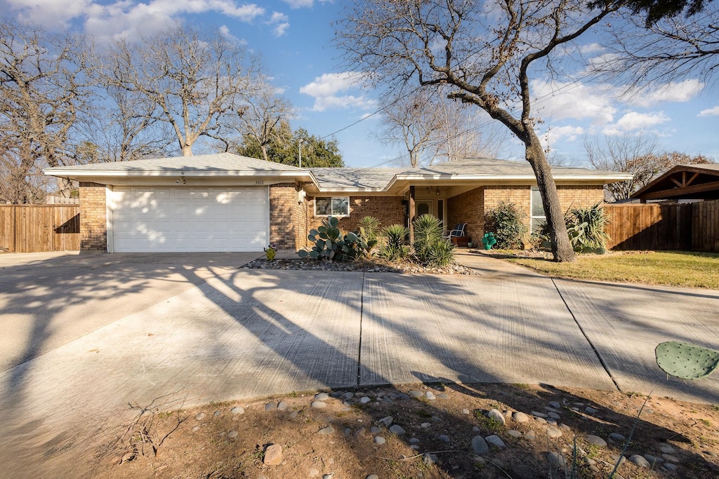 ranch-style home featuring a garage