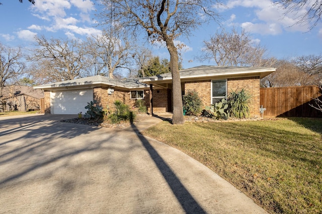 ranch-style home featuring a garage and a front yard