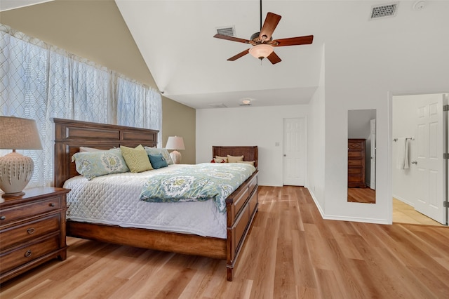 bedroom with ceiling fan, light wood-type flooring, and high vaulted ceiling