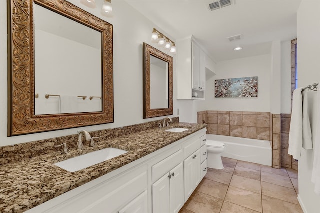 bathroom with vanity, a bath, tile patterned floors, and toilet