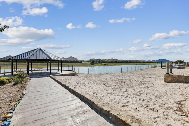 view of property's community with a water view and a gazebo