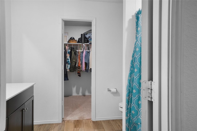 bathroom featuring vanity, toilet, and hardwood / wood-style floors