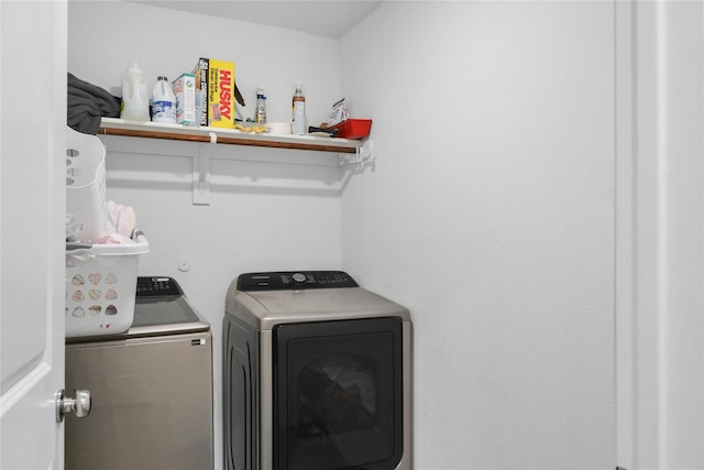 clothes washing area featuring independent washer and dryer