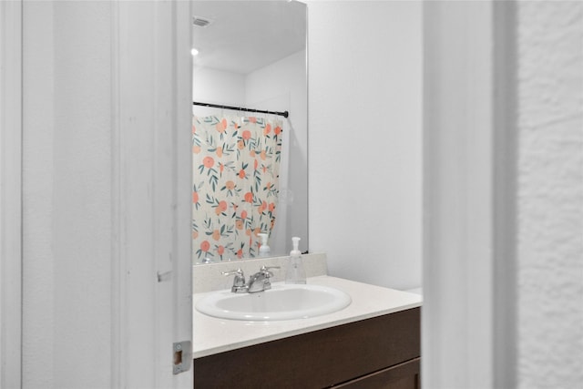 bathroom with vanity and a shower with shower curtain