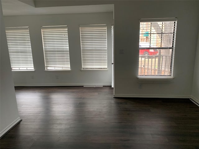 empty room with dark hardwood / wood-style flooring