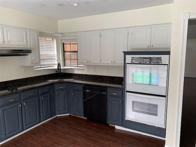 kitchen featuring dark hardwood / wood-style floors, white cabinetry, sink, dark stone counters, and black appliances