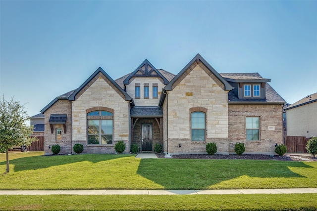 french country inspired facade featuring a front lawn