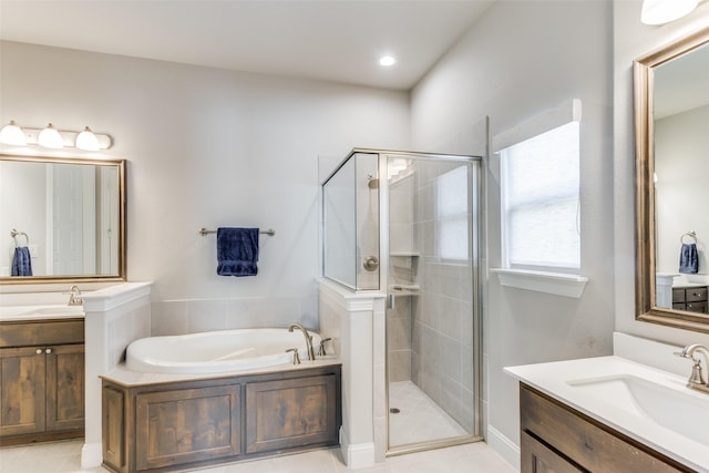 bathroom featuring shower with separate bathtub, tile patterned floors, and vanity