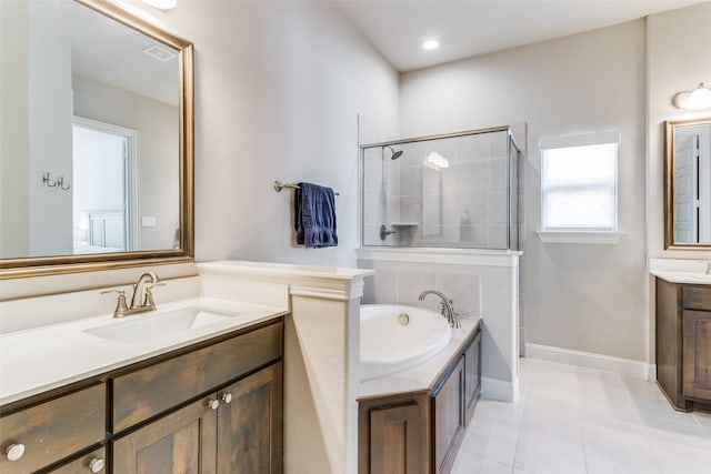 bathroom featuring plus walk in shower, tile patterned flooring, and vanity