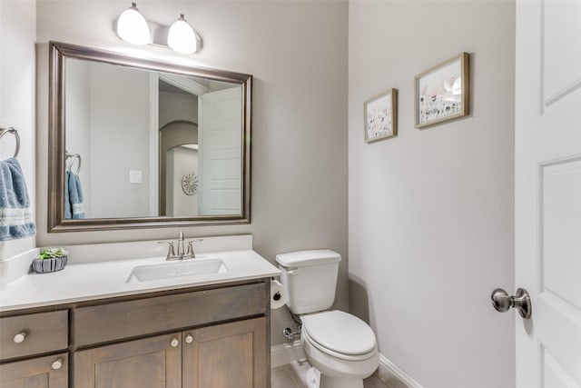 bathroom featuring toilet and vanity