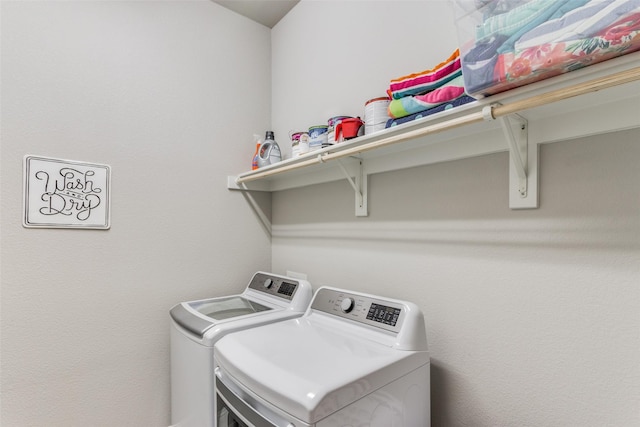 clothes washing area with washing machine and clothes dryer