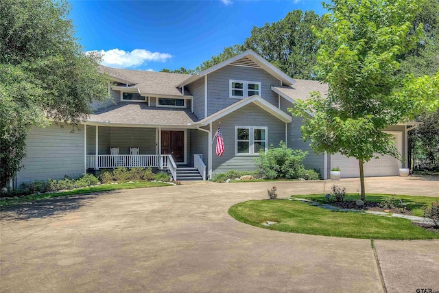 view of front of home featuring a garage and a porch