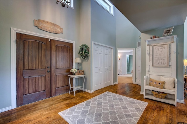 foyer with a towering ceiling and hardwood / wood-style floors